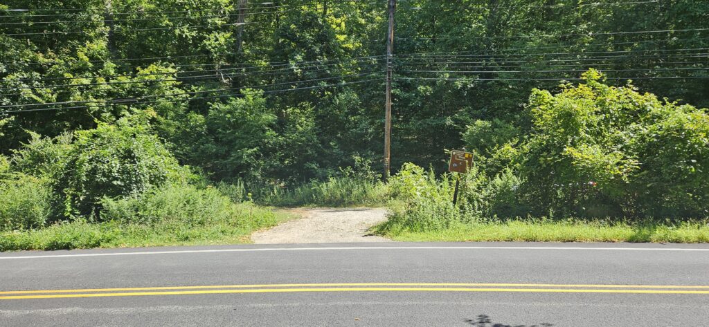 a road with trees and a sign