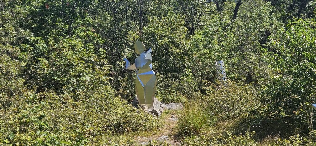 An image of a sculpture of a woman made of metal