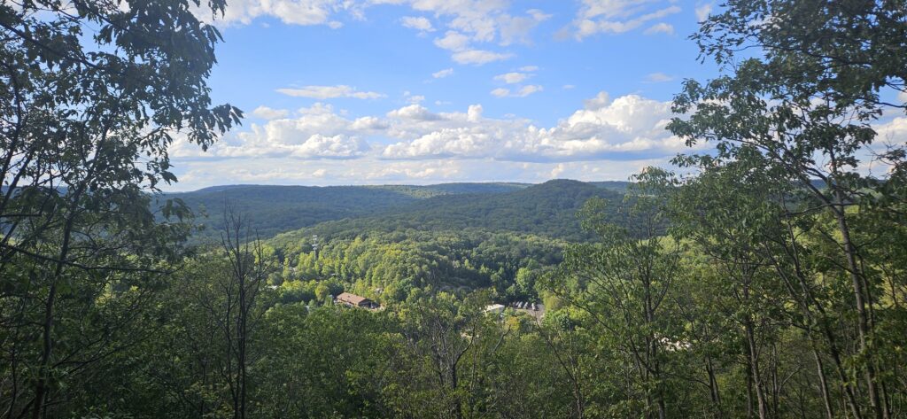 A scenic view featuring multiple small mountains