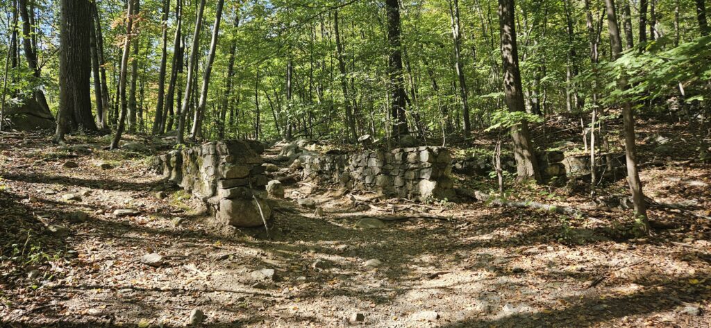 An image of a hiking trail passing through some ruins