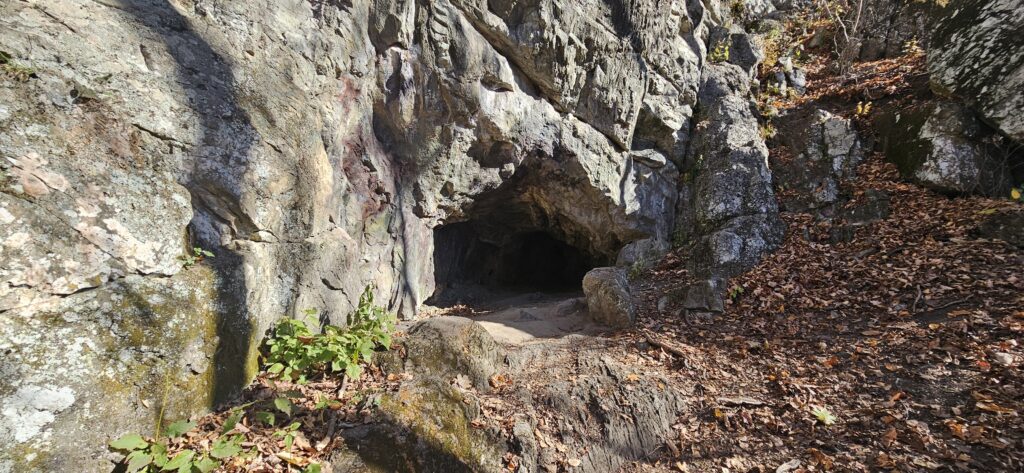 An image of a cave in the side of a hill
