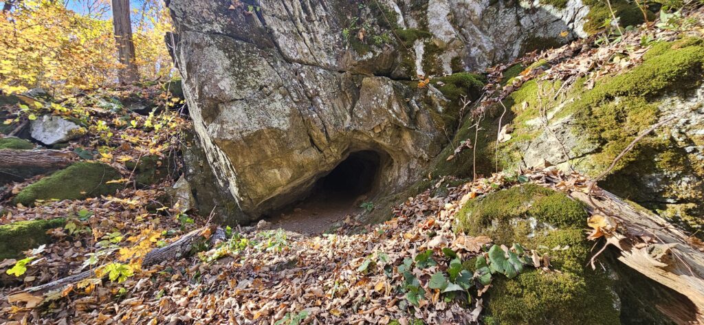 An image of the Fairly Low Cave, a small cave in the side of a hill