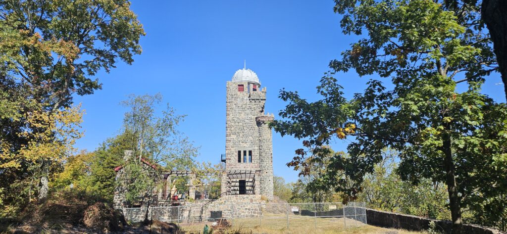 An image of a historic tower surrounded by construction fencing