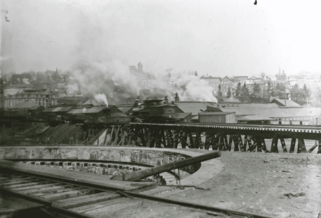 Historic train passing through industrial area
