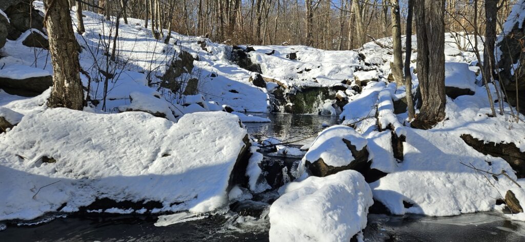 An image from below Otter Hole Falls in the winter