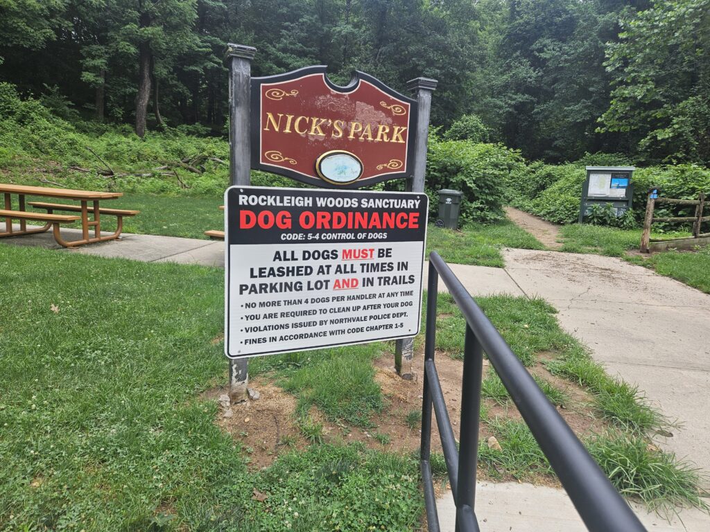 A sign for Nicks Park and a large dog ordinance sign in Rockleigh New Jersey 