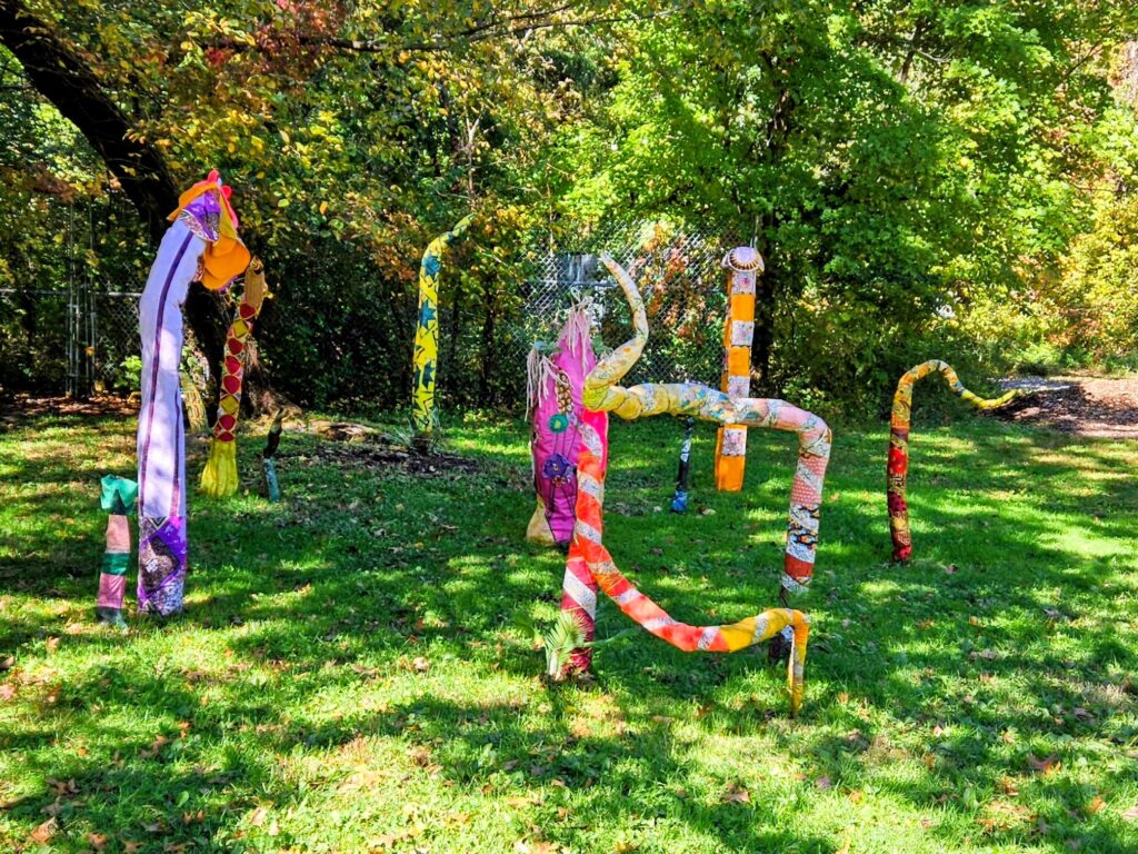 A colorful, abstract piece of art titled "Grief Circus" and created by HAMEWS at South Mountain Reservation